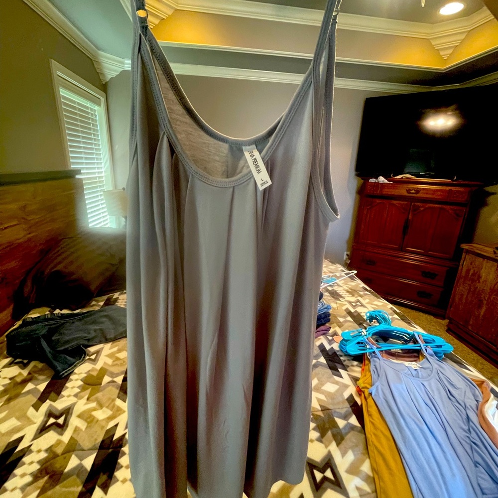 Pleated tanks.  Size large will fit up to 2x. Very loose fitting  multi colors